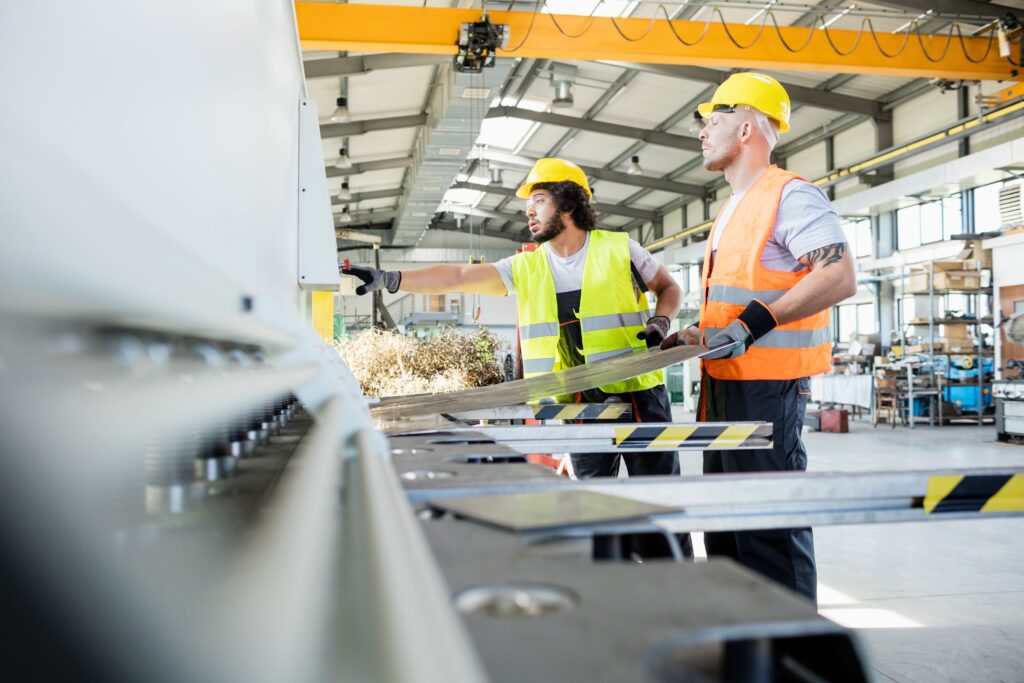 The industrial sector, workers on a metal working machine folding metal